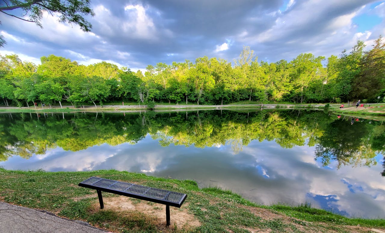 hero-img-01 Peaceful reflections on a calm lake at Alexandria Community Park, KY.